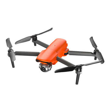 Orange Autel EVO Lite drone in mid-flight, angled view with extended propellers
